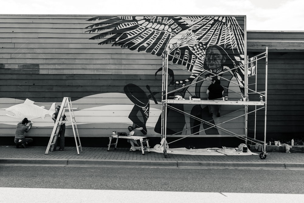 A mural being painted on a Hazelton building