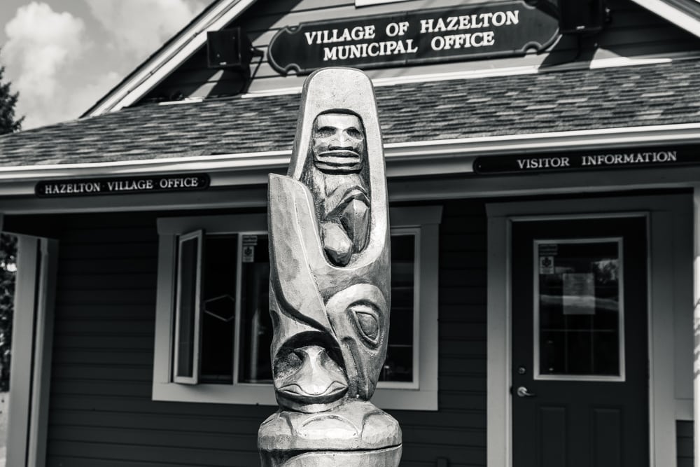 A carved pole in front of the Village of Hazelton Municipal Office